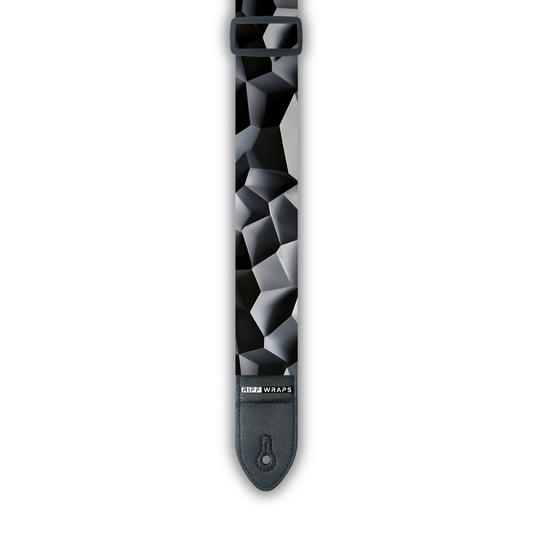A black padded guitar strap with a geometric voronoi texture pattern.