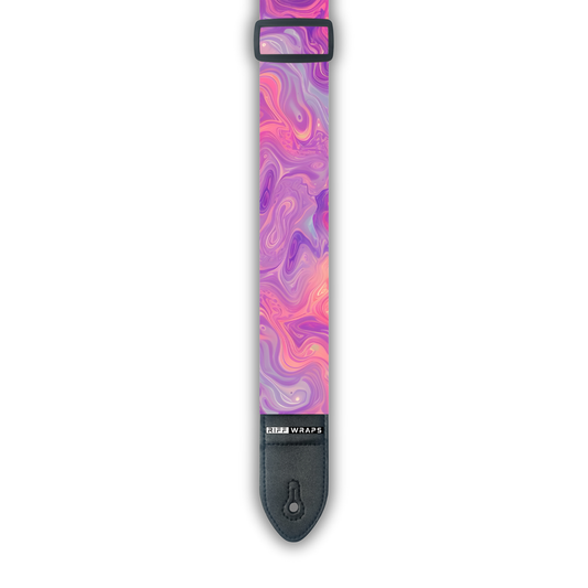 A padded guitar strap with a pink and purple swirl pattern, featuring a buckle and a leather-look end.